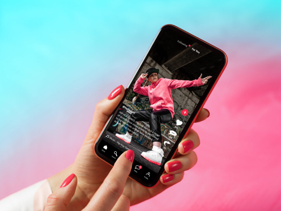 Hand holding smartphone displaying TikTok app for short-form video marketing in South Africa